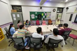 Alumni meeting around tables at the school