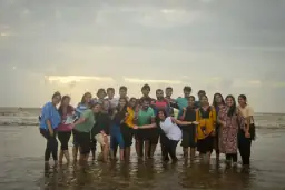 Alumni together at the seashore during the Palghar outing