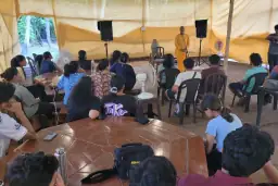 Participants seated under a canopy during the outing
