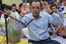 A singer leads the 2025 Nirjal Ekadashi kirtan as the group claps along.