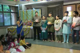 Alumni standing at the front of a working committee gathering